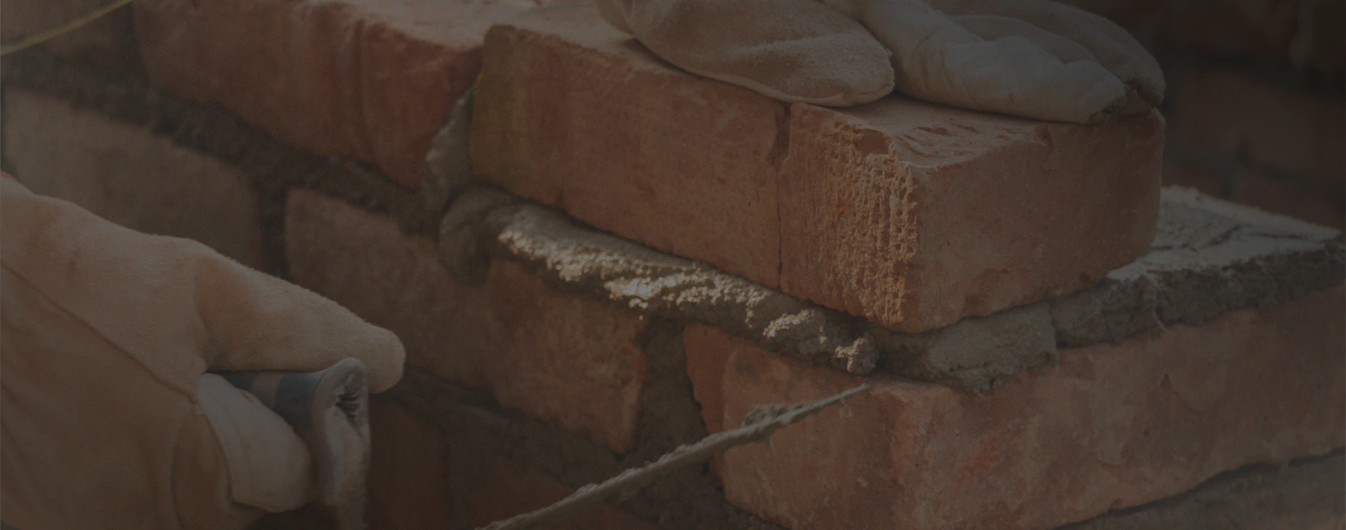close up installing new brick wall